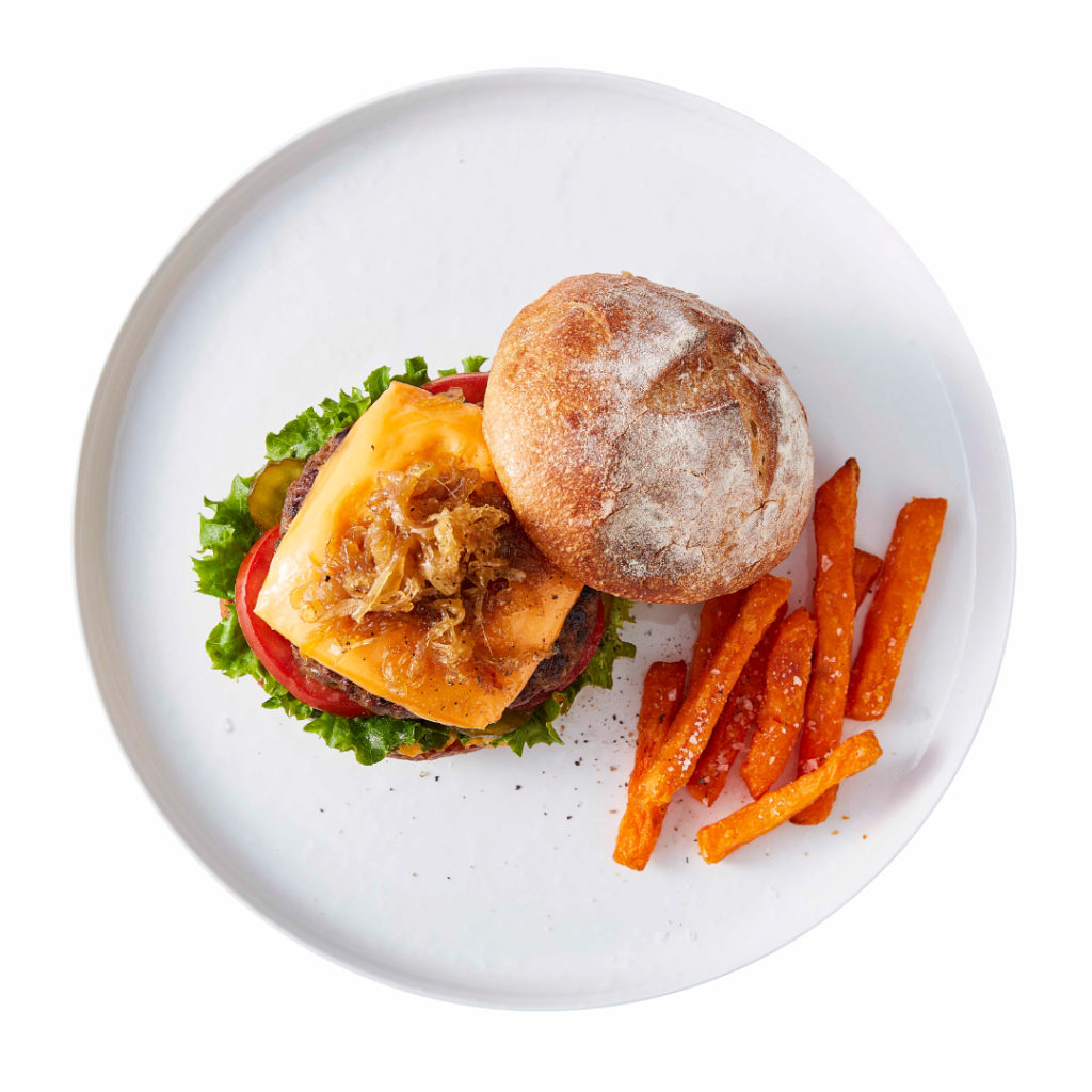 If you like your burgers big and juicy than this classic beef burger recipe is for you. Topped with caramelized onions tomatoes and pickles. Serve with Sweet Potato Fries to make it the ultimate meal.